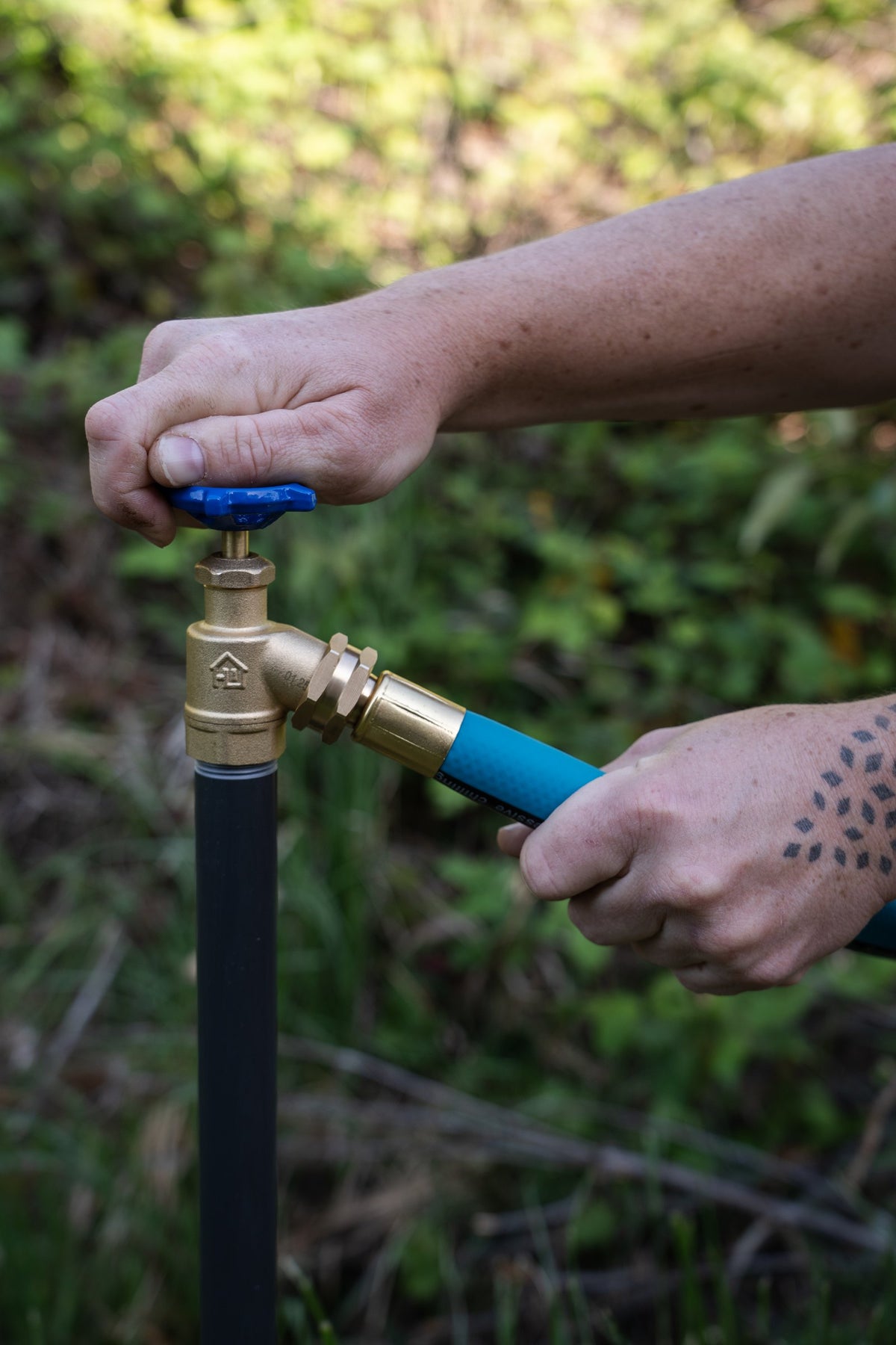 THE HOSE threaded onto a garden spigot by hand