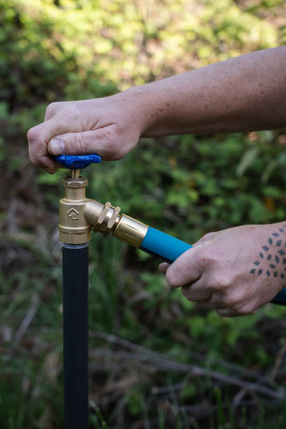 THE HOSE threaded onto a garden spigot by hand