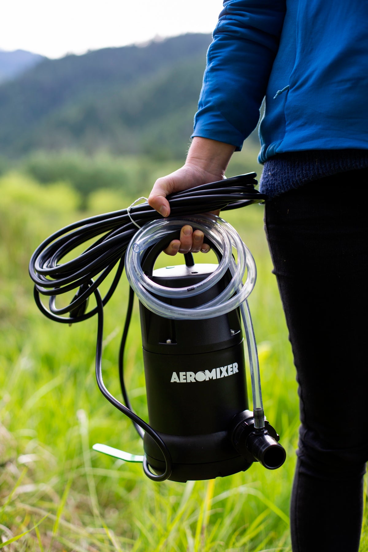 Aeromixer carried by the handle with its cord and air hose coiled