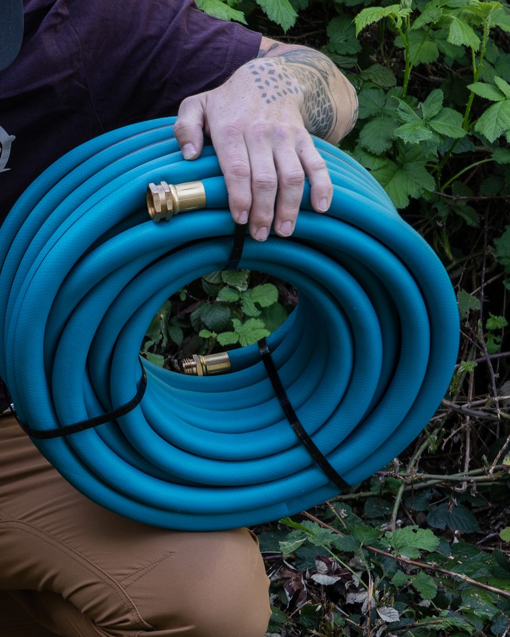 Carrying a coil of THE HOSE 3/4-inch, brass ends out